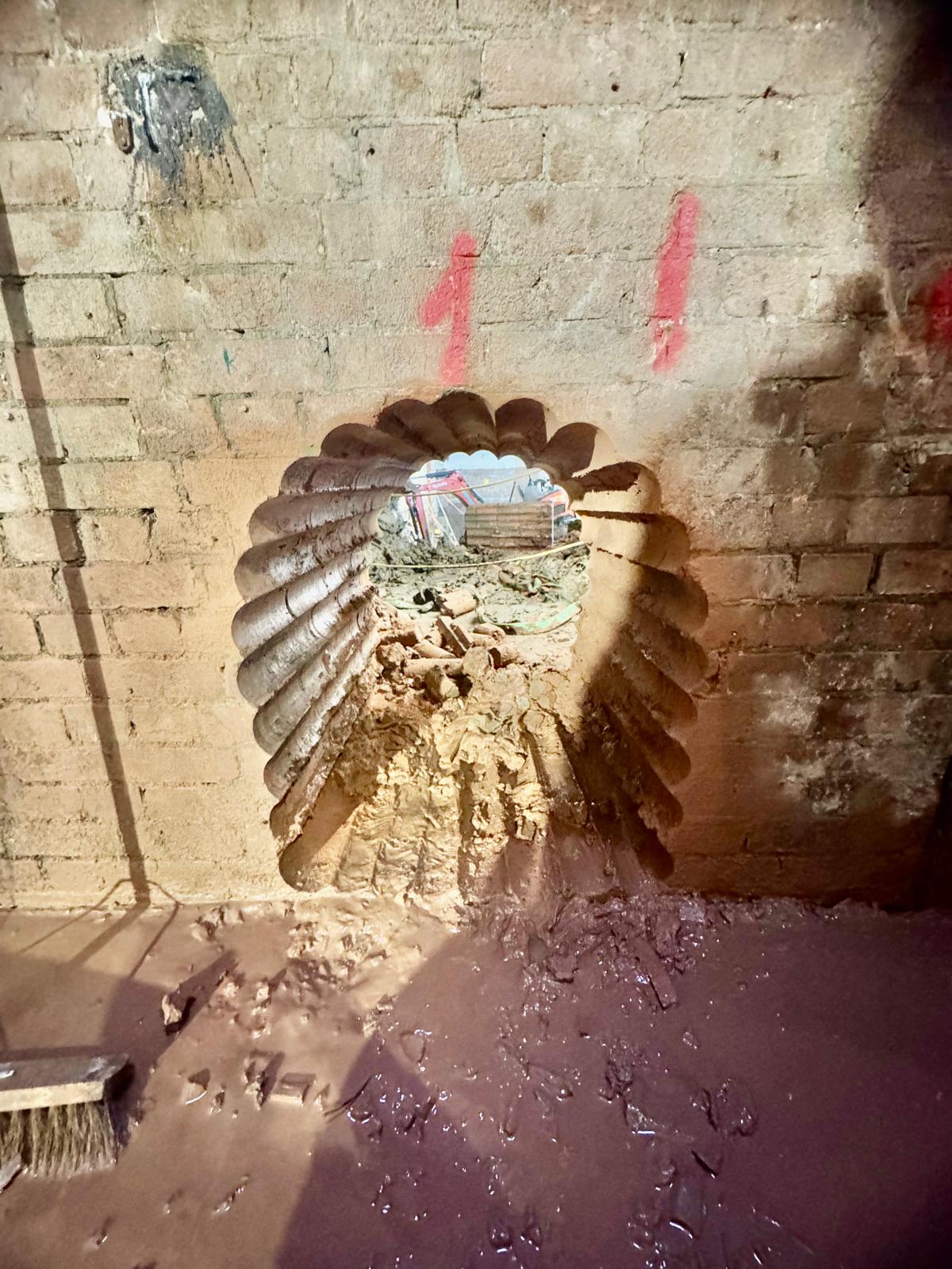 Large-diameter core drilled through a thick block wall for a new service penetration.